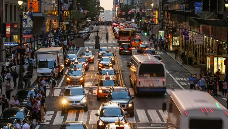 Busy Palo Alto street traffic at dusk representing urban noise pollution requiring acoustic testing